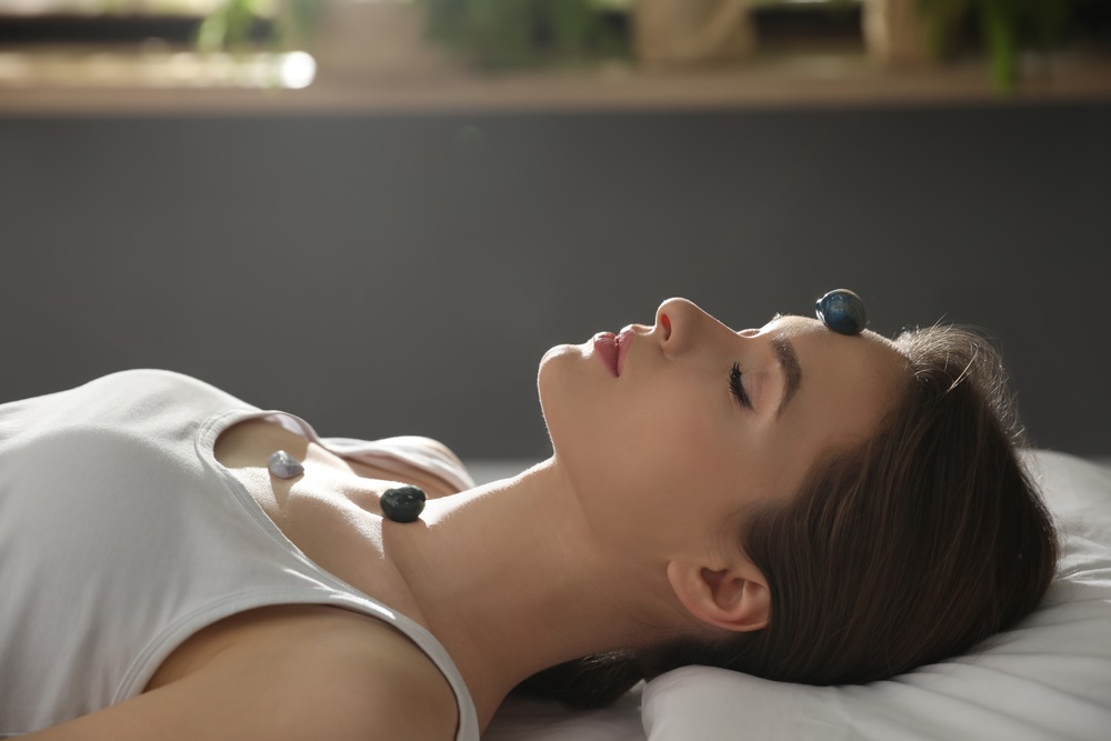 Person meditating in a serene environment for long distance Reiki preparation