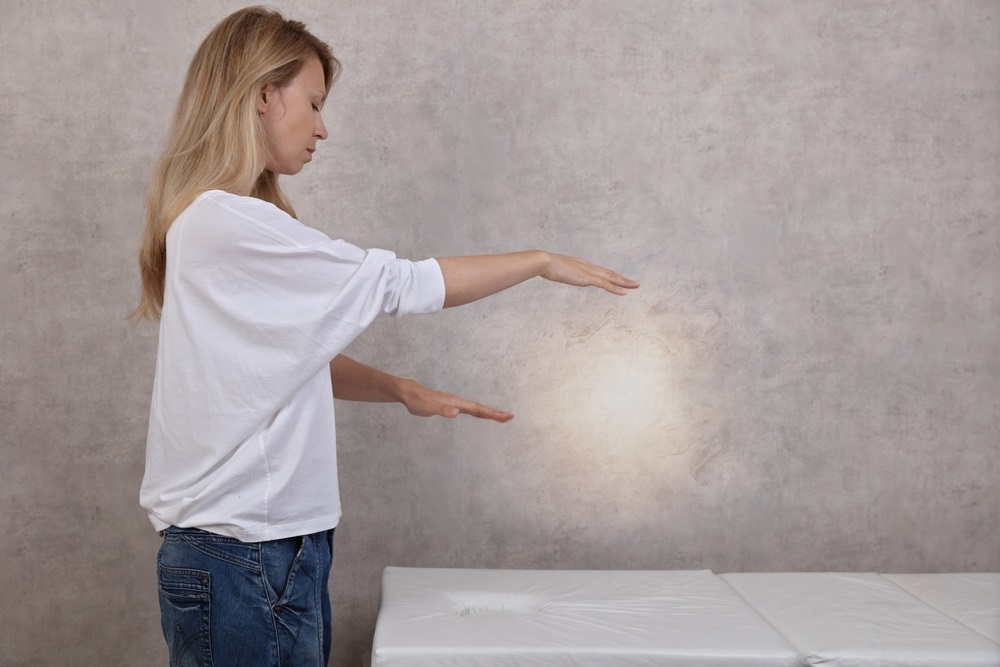 Person meditating in a serene environment for long distance Reiki preparation