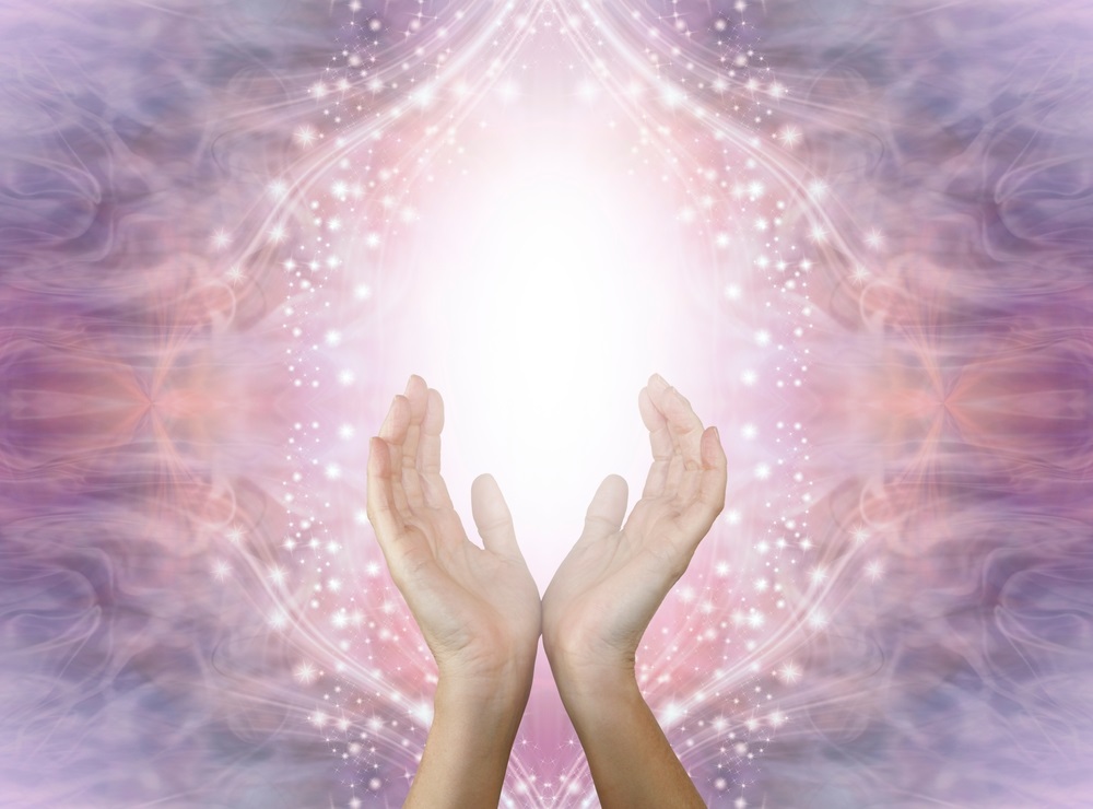 A pair of hands in a calming Reiki hand position, demonstrating techniques for anxiety relief.