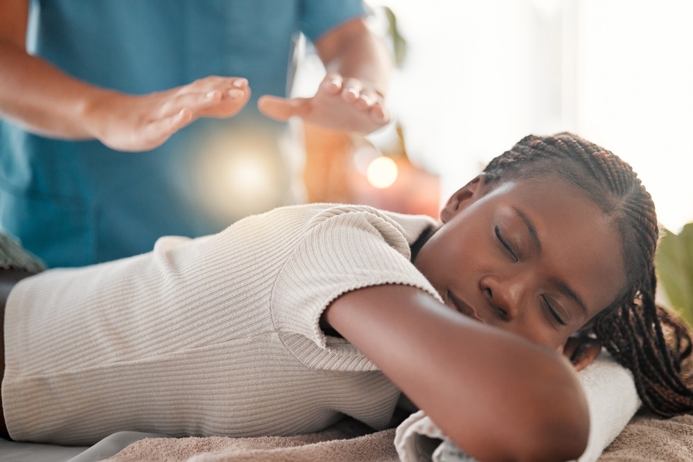 A pair of hands in a calming Reiki hand position, demonstrating techniques for anxiety relief.