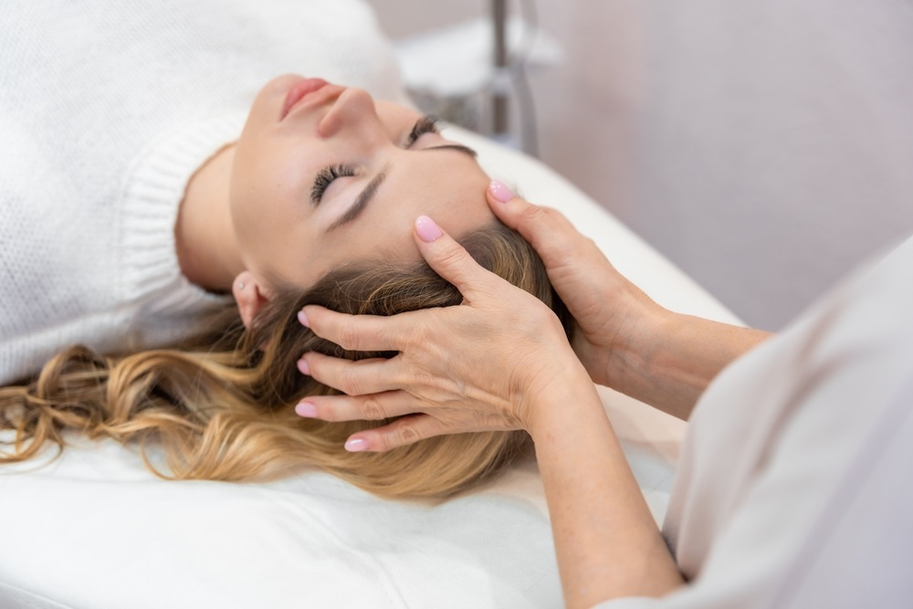 Person practicing energy healing exercises with radiant energy flow in a peaceful environment.