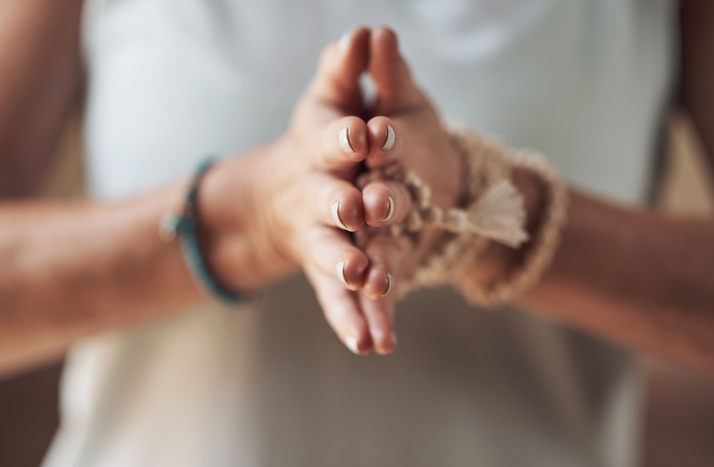 Person practicing energy healing exercises with radiant energy flow in a peaceful environment.