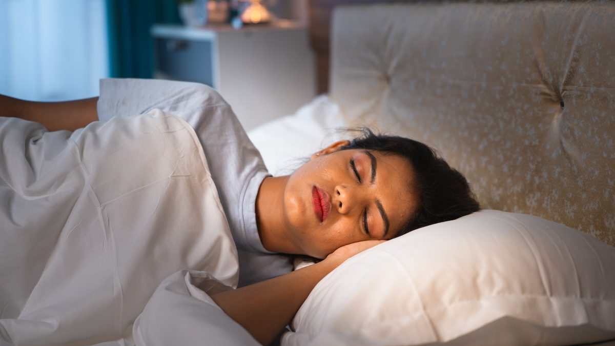 Person sleeping peacefully in a calm bedroom environment