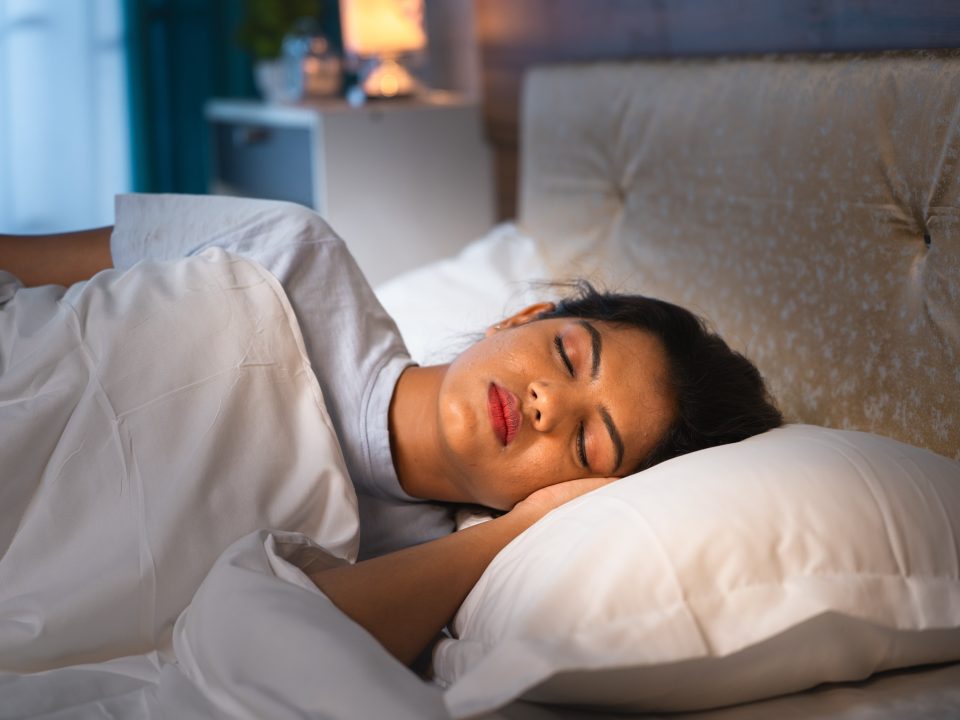 Person sleeping peacefully in a calm bedroom environment